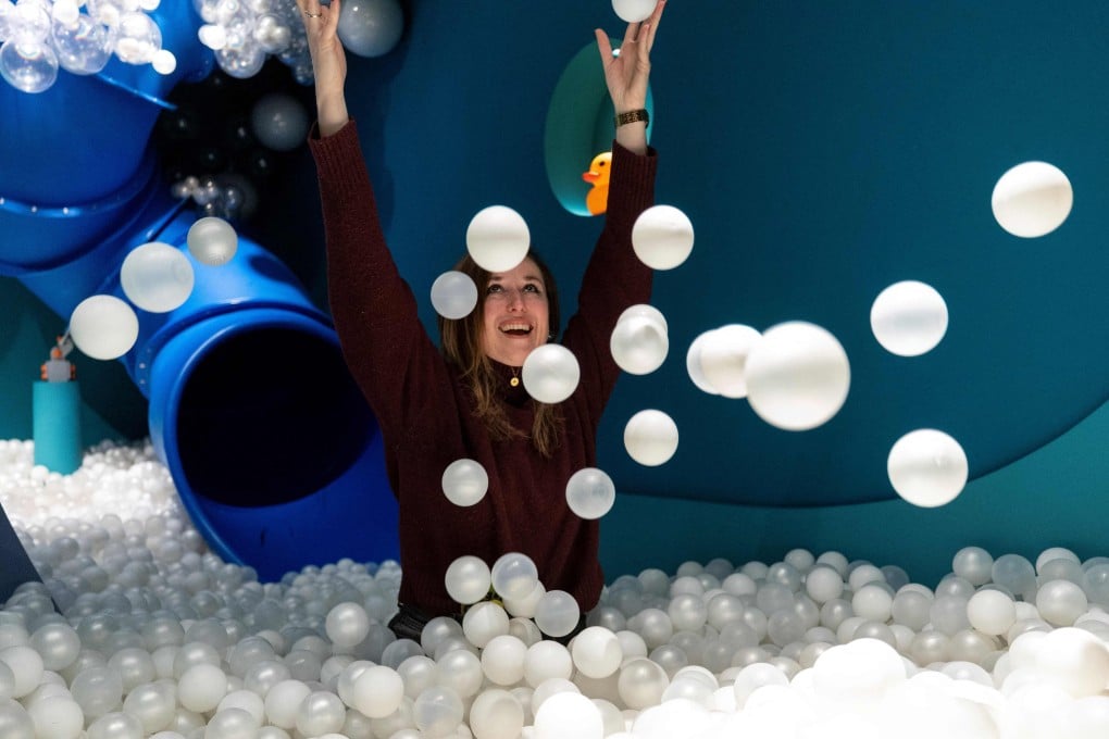 Andrea Golubic inside a pool full of small white balls at the HaHaHouse museum of laughter, which she founded in central Zagreb, Croatia. Photo: AFP