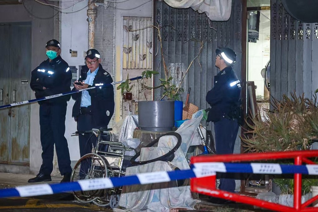 Police outside the two elderly victims’ ground-floor flat in Chun Hing San Tsuen, off Wang Tat Road, in Yuen Long, at about 8pm. Photo: Handout