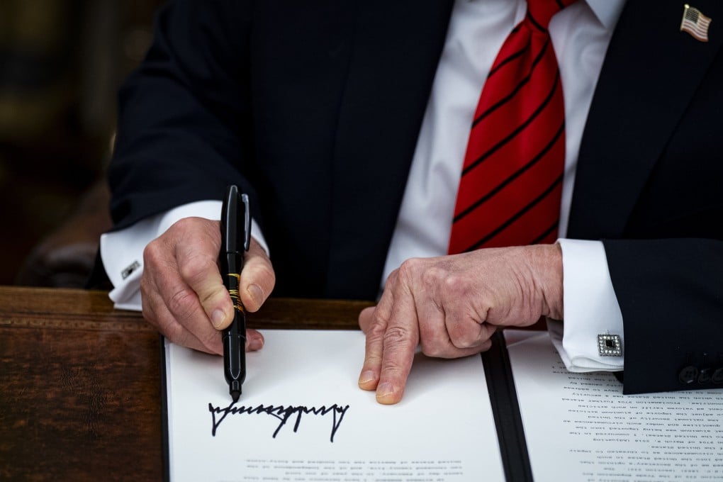US President Donald Trump signs an executive order in Washington on Monday imposing 25 per cent tariffs on all steel and aluminium imports. Photo: EPA-EFE