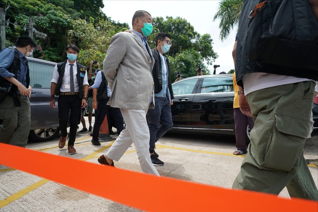Police with Apple Daily founder Jimmy Lai in August 2020. Photo: Felix Wong