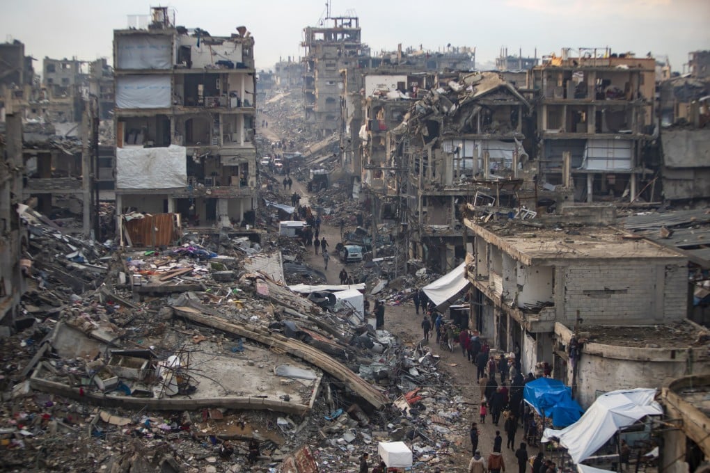 Palestinians walk in the destruction caused by the Israeli air and ground offensive in Jabaliya, Gaza Strip. Photo: AP
