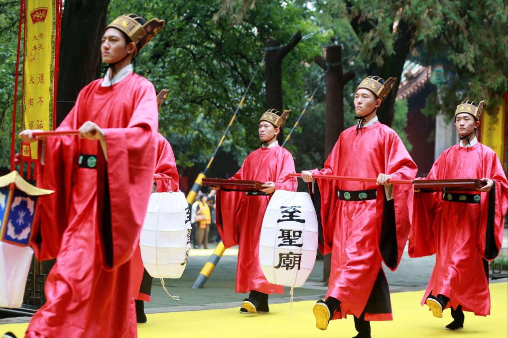 People dressed as ancient Chinese scholars attend a memorial ceremony to mark the 2,572nd anniversary of the birth of Confucius at the Confucius Temple on September 28, 2021 in Qufu in China’s Shandong province. Photo: Getty Images