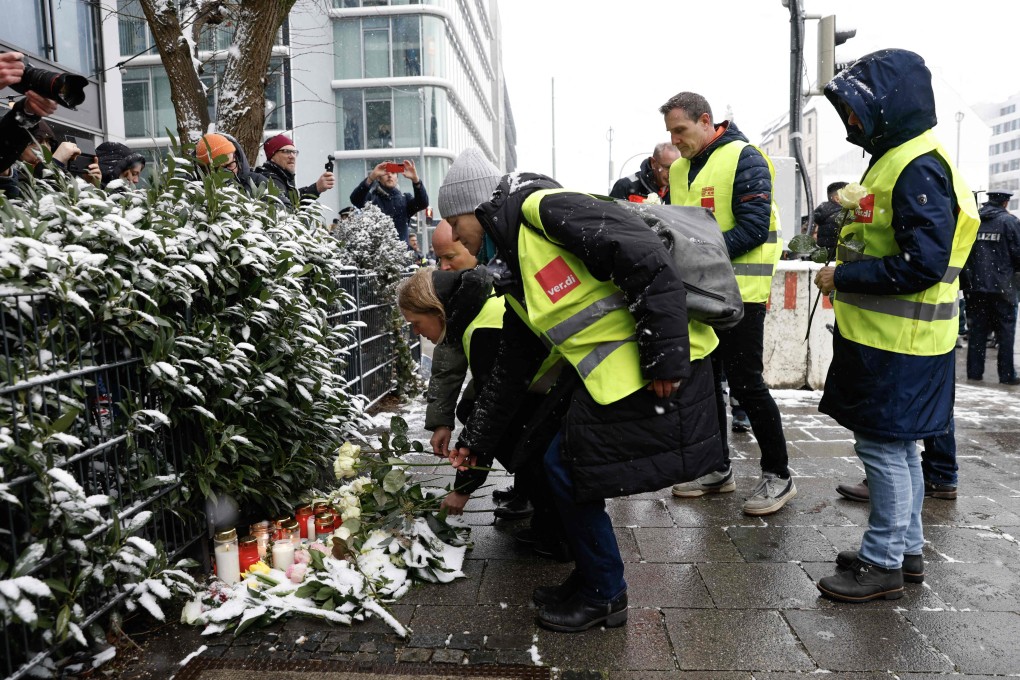 Members of German union Ver.di pay their respects on Friday at the scene where a car drove into a crowd in the southern German city of Munich on February 13. Photo: AFP
