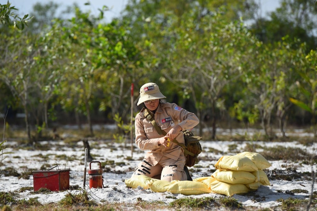 A member of a demining team prepares to detonate unexploded ordnance in Vietnam’s Quang Tri province: Photo: AFP