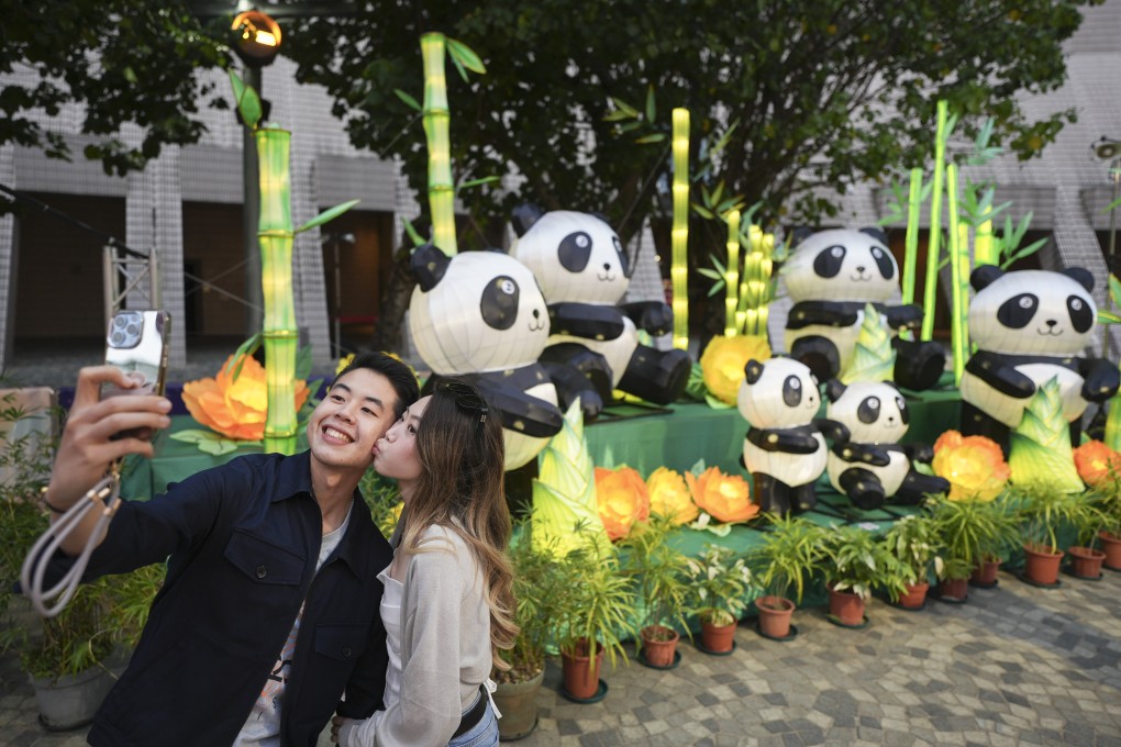A couple poses in front of panda lanterns at the Hong Kong Cultural Centre. Photo: Eugene Lee