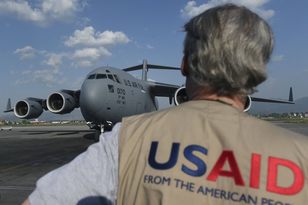 A USAID officer watches as a US military cargo plane taxis to a stop at an airport in Kathmandu, Nepal, in 2015. Photo: AFP