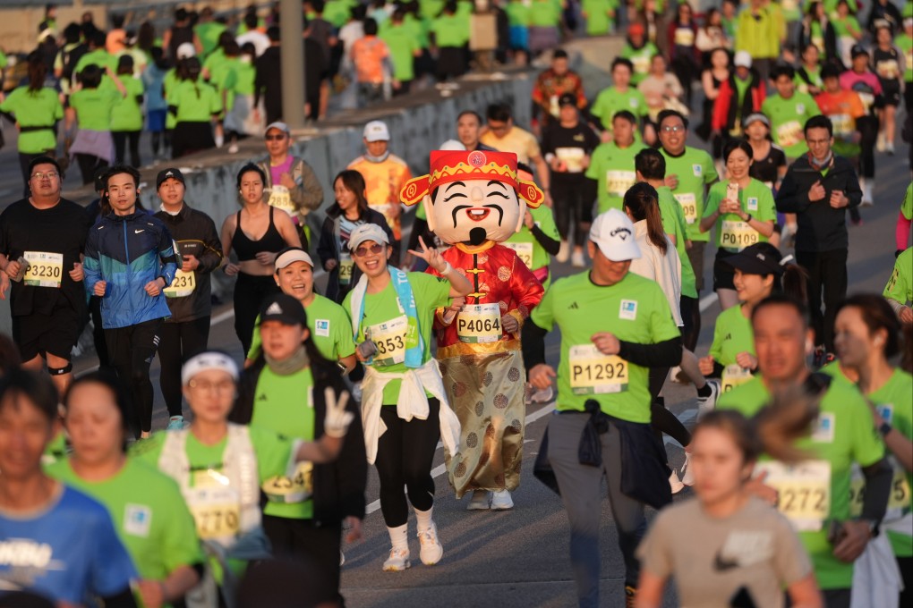 A runner dressed as the God of Wealth is spotted at the Island Eastern Corridor in North Point during a Standard Chartered Hong Kong Marathon event on February 9. Photo: Eugene Lee