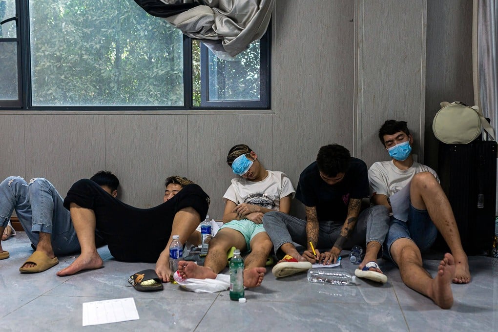 Alleged scam centre workers and victims rest during a crackdown operation by the Karen Border Guard Force (BGF) on illicit activity, in Shwe Kokko in Myanmar’s eastern Myawaddy township, on Friday. Photo: AFP