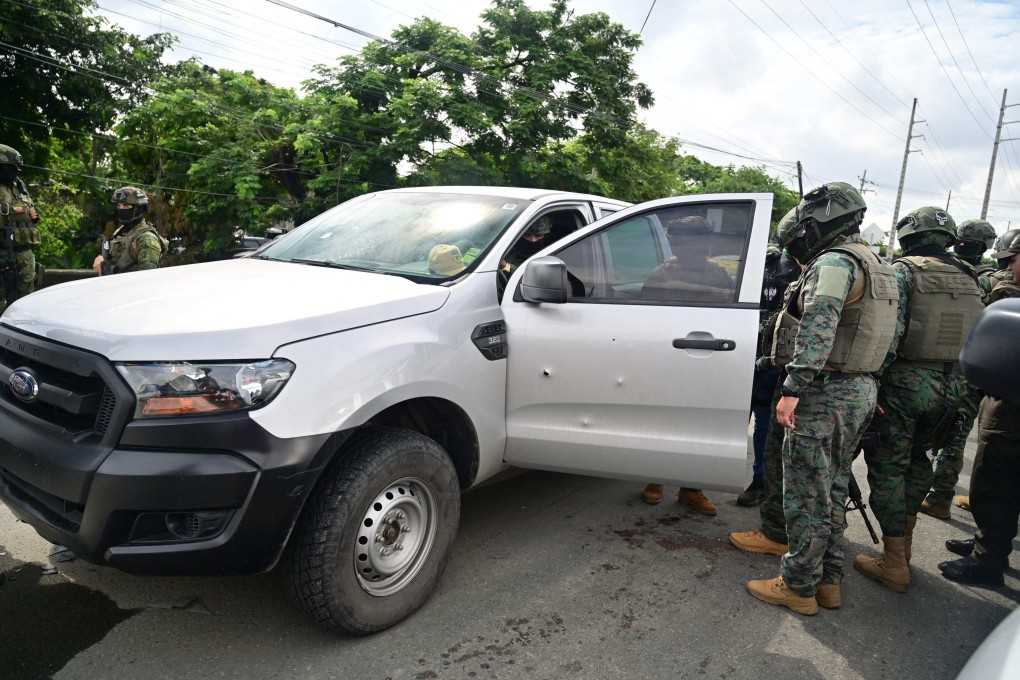 Military officers inspect the pickup truck in which a colonel of the Ecuadorian Armed Forces was murdered in Guayaquil, Ecuador, on Friday. Photo: AFP