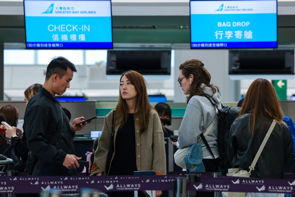 Passengers queue at a Greater Bay Airlines counter at Hong Kong International Airport. Photo: Jelly Tse