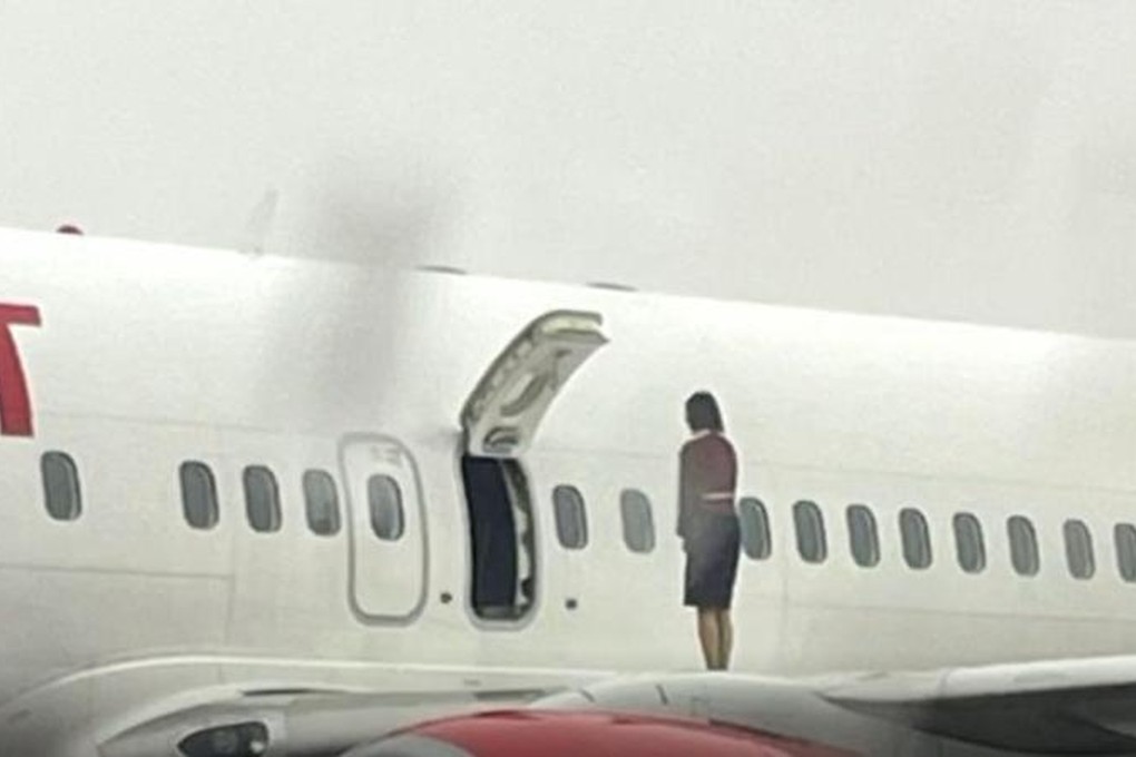 A crew member of an Eastar Jet flight stands on the wing of an aircraft at Cheongju Airport. Photo: JTBC