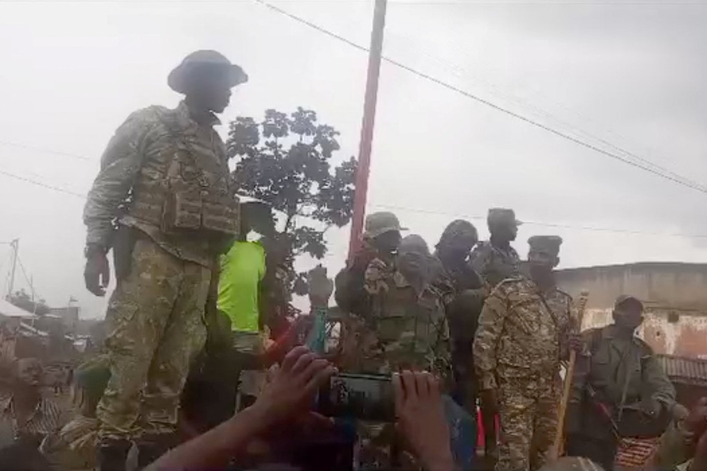 A person in military clothing speaks to a gathered crowd in Katana, a town near Kavumu airport that has been captured by M23 rebels. Photo: Social media via Reuters
