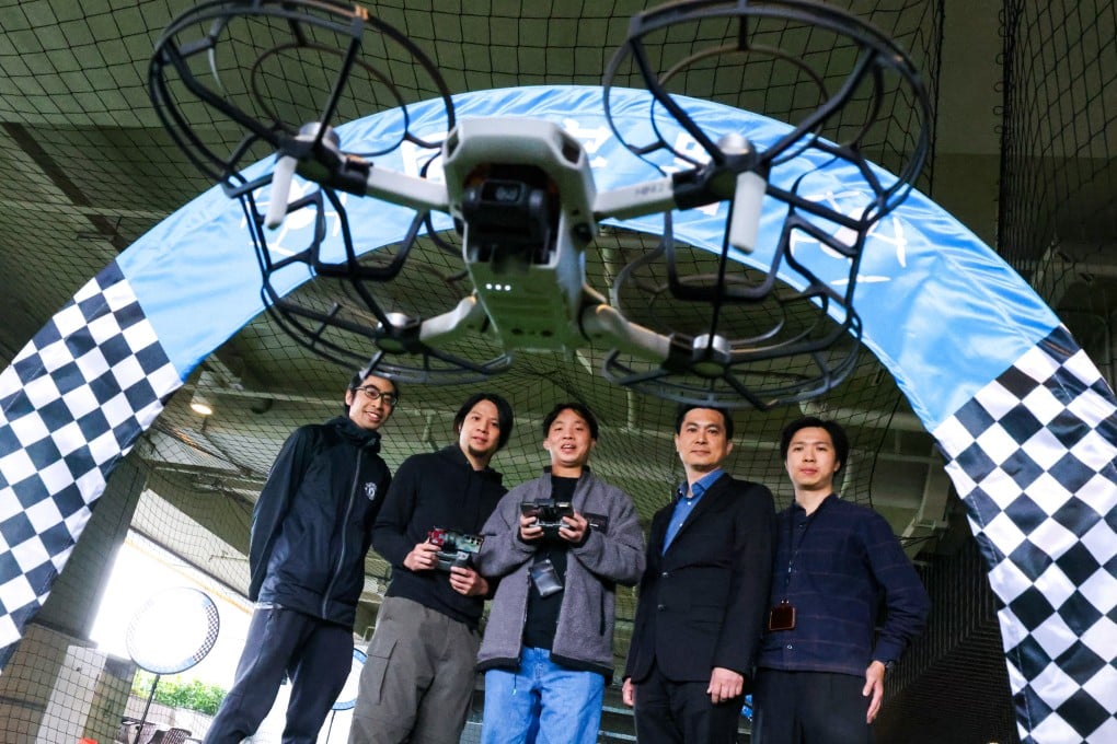 Larry Wong (fourth left) joins drone tutors and trainees for a demonstration. Photo: Nora Tam