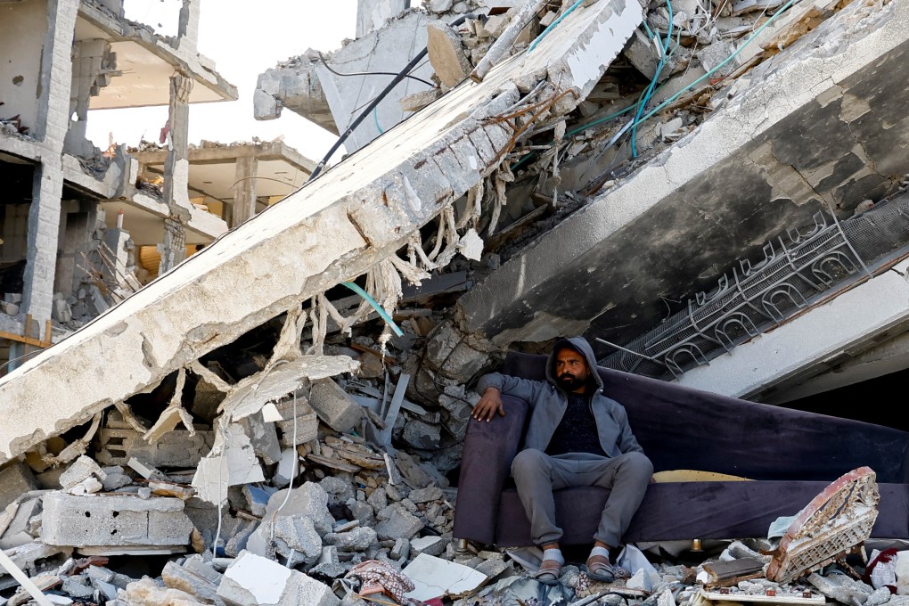 A Palestinian man sits amidst the rubble of buildings destroyed during the Israeli offensive, in Rafah in the southern Gaza Strip on Sunday. Photo: Reuters