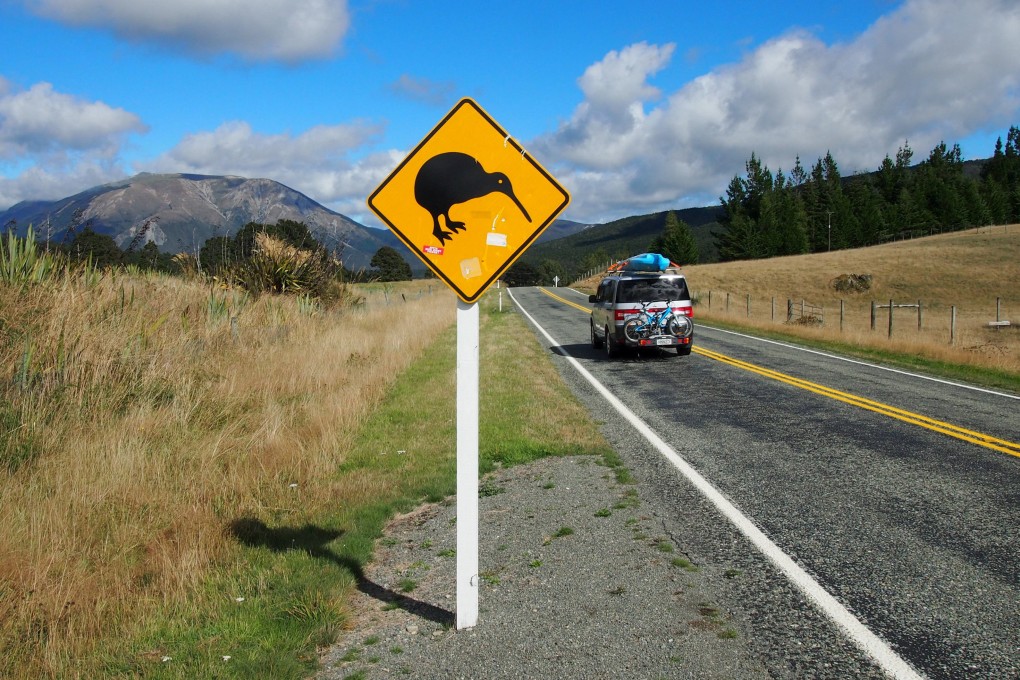 A car drives past a road sign on the South Island of New Zealand. Photo: Reuters