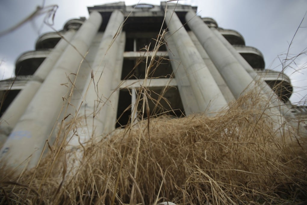 Weeds grow on a balcony of the Sathorn Unique building in Bangkok, Thailand. Photo: AP