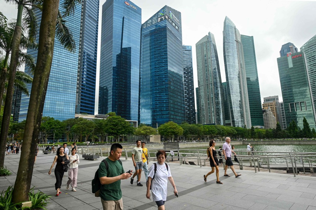 People walk along the promenade at Marina Bay in Singapore in January. The city state will unveil its budget on Tuesday. Photo: AFP
