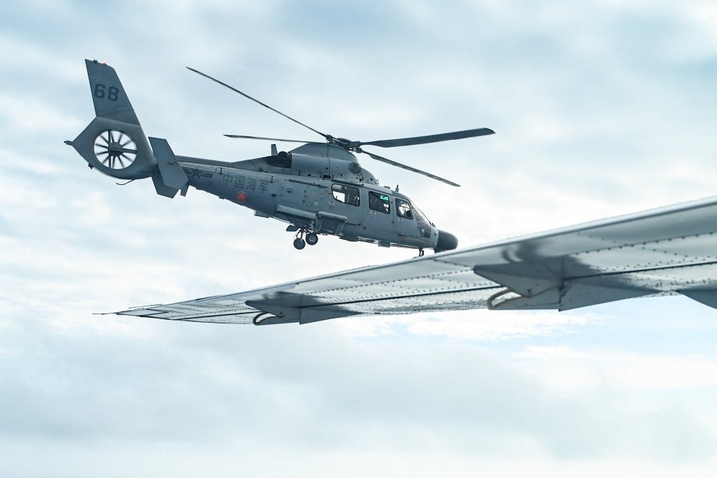 An aircraft identified by the Philippine Coast Guard as a Chinese navy helicopter flies near a Bureau of Fisheries and Aquatic Resources plane during an aerial reconnaissance flight over Scarborough Shoal on Tuesday. Photo: AFP