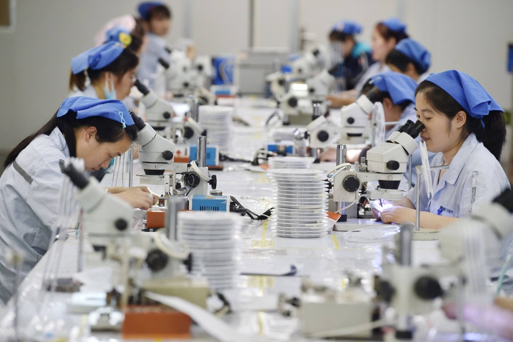 Workers produce electronic components at a factory in Suqian, in Jiangsu province, in 2023. Photo: AFP