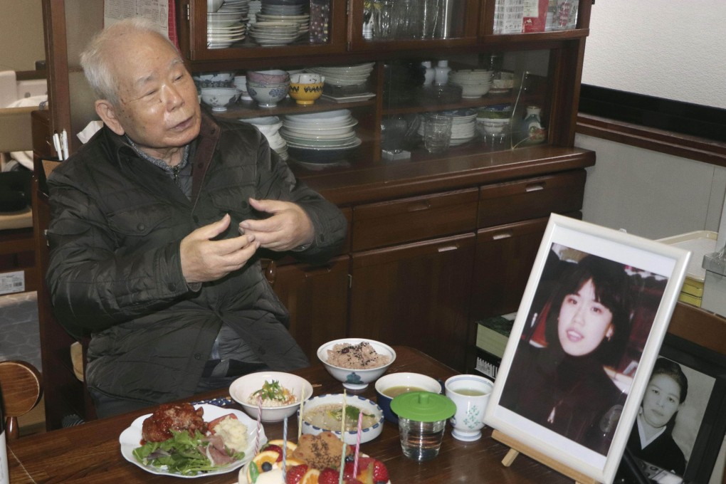 Akihiro Arimoto, whose daughter Keiko was taken to North Korea in 1983 at age 23, pictured in 2020 with her photo. Photo: Kyodo