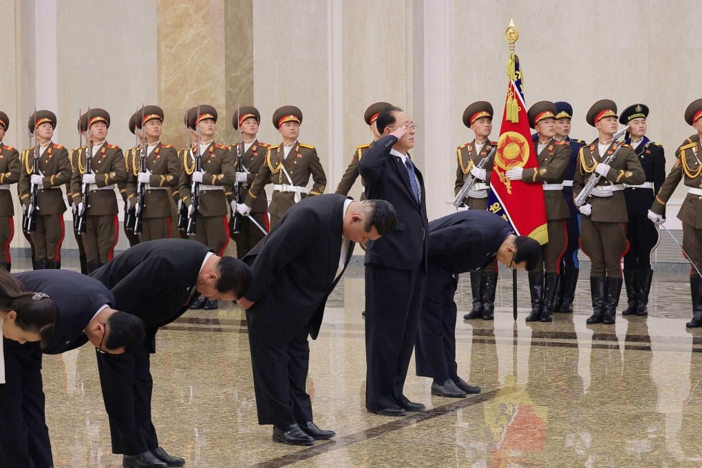 North Korean leader Kim Jong-un (fourth from left, bowing) visits the Kumsusan Palace of the Sun in Pyongyang to mark the 83rd anniversary of the birth of Kim Jong-il on Sunday. Photo by KCNA via KNS / AFP