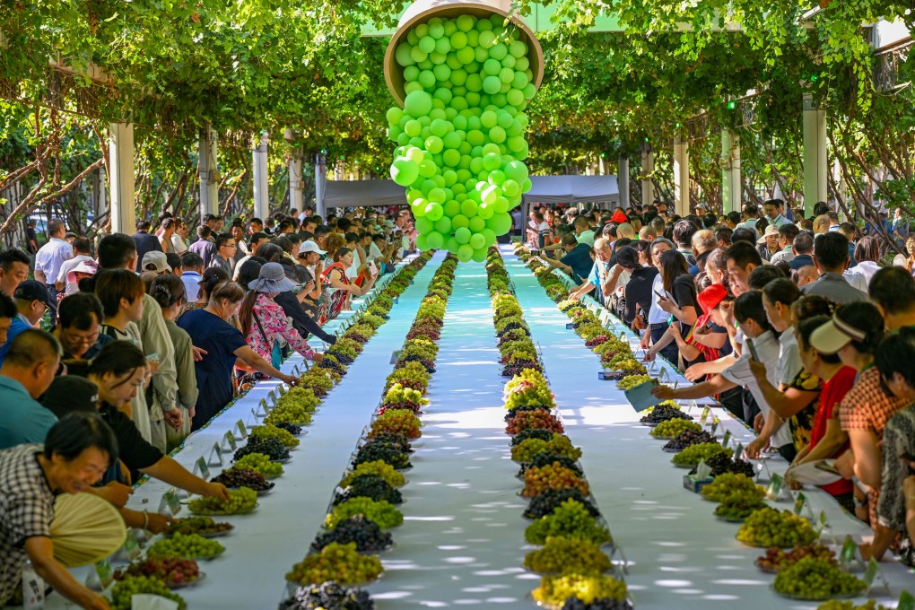 Tourists taste grapes at the 30th China Silk Road Turpan Grape Festival in Xinjiang, on August 17. Turpan, China’s main grape producer, has more than 550 types, making it the “vineyard of the world”. As a renowned culinary capital and an international wine trading hub, Hong Kong is ideally positioned to showcase these products. Photo: Xinhua