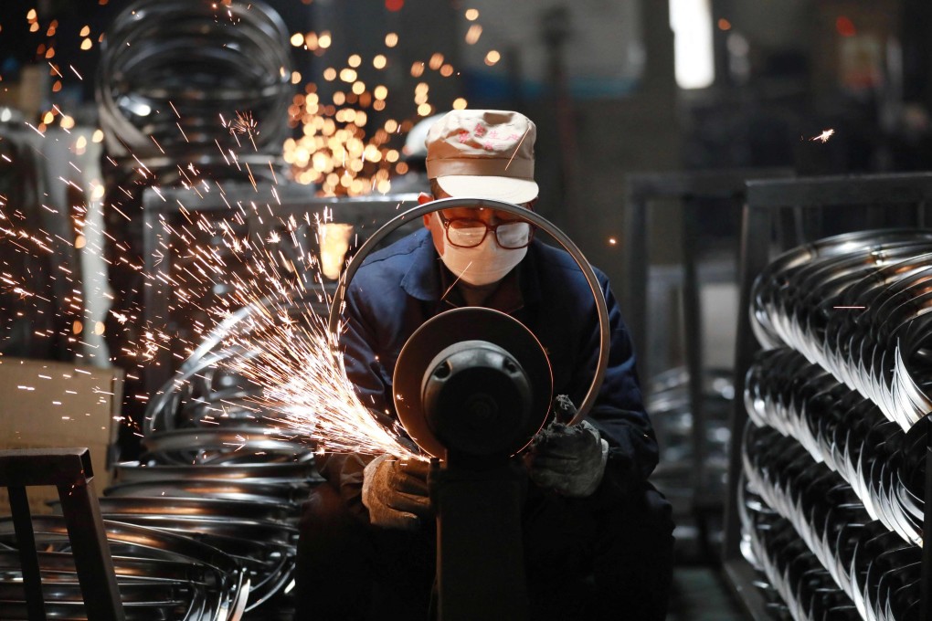A worker polishes steel bicycle rims at a factory which produces bicycle parts for export, in Hangzhou, in eastern Zhejiang province, on February 11. Photo: AFP