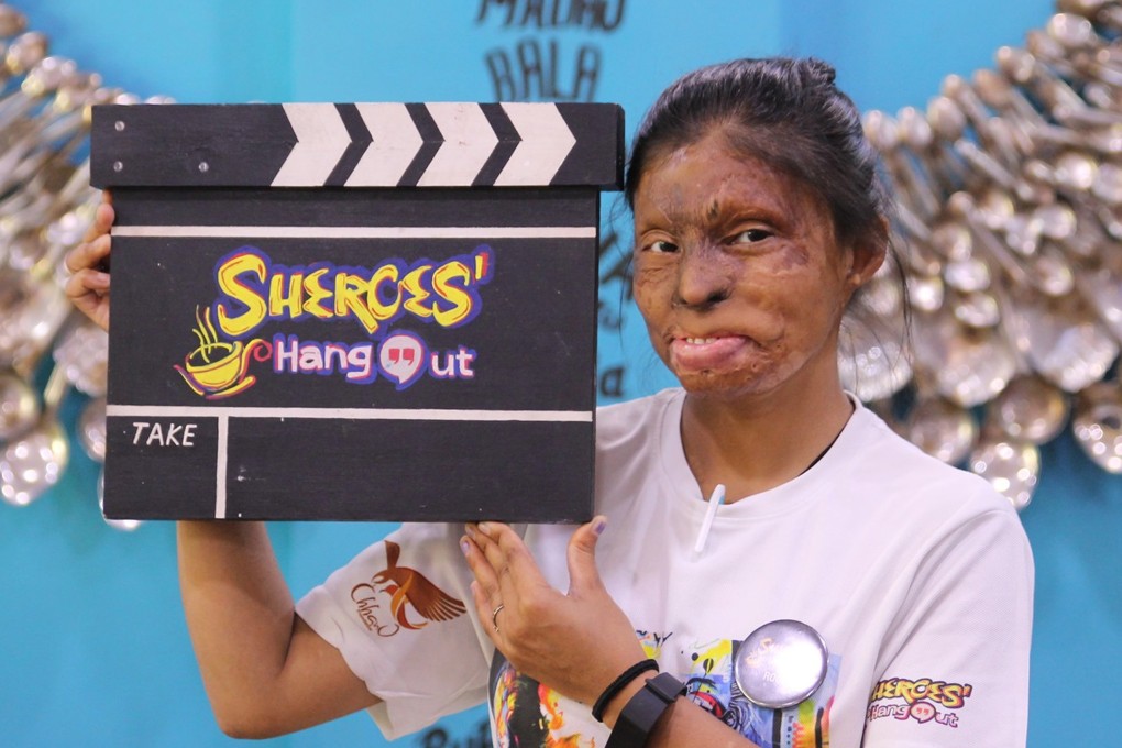An employee of Sheroes Hangout holds a sign with the cafe’s name on it. Three Sheroes Hangout cafes in India’s Uttar Pradesh state employ about 50 victims of acid attacks. Photo: Facebook/Sheroes Hangout