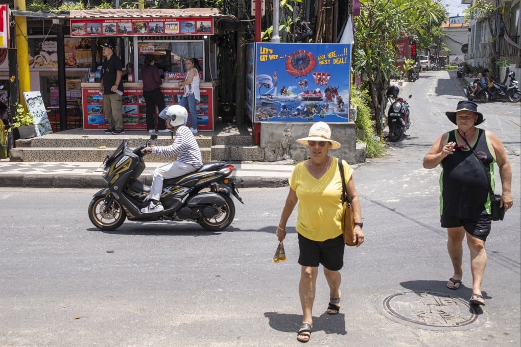 Tourists wander at Kuta Beach in Bali, Indonesia, on February 3. Photo: EPA-EFE