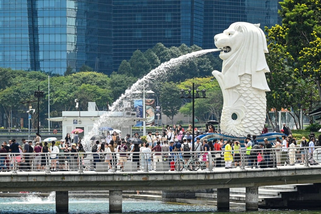 People gather next to the Merlion statue at Marina Bay waterfront in Singapore on February 13. Photo: AFP
