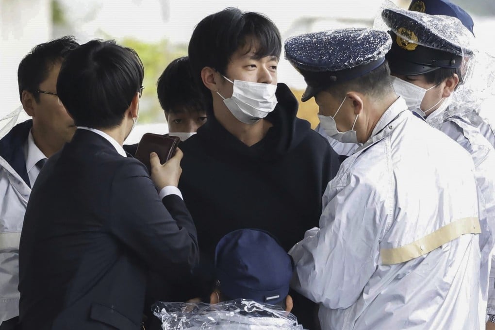 Ryuji Kimura (centre) is apprehended by police after he threw a homemade pipe bomb at Japan’s former prime minister Fumio Kishida in Wakayama, western Japan, on April 15, 2023. Photo: Kyodo News via AP