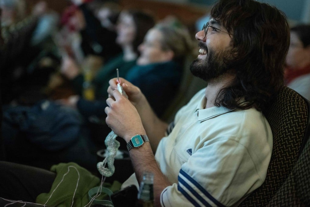 A man knits during a showing of The Devil Wears Prada at the Votive Cinema in Vienna, Austria. These sold-out crafty film showings happen once a month. Photo: AFP