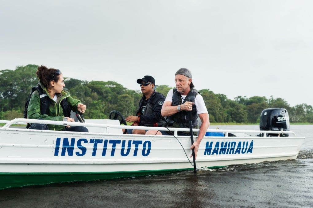 Michel André (far right) deploys a hydrophone into a river with his team to record underwater sounds for research at Brazil’s Mamirauá Sustainable Development Reserve. Photo: Rolex/Diego Bresani