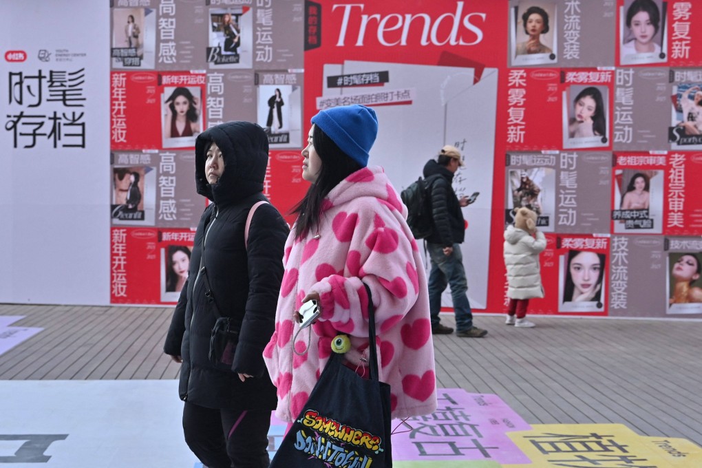 People walk past advertising for Chinese social networking and e-commerce app RedNote at a shopping centre in Beijing on January 15. Photo: AFP