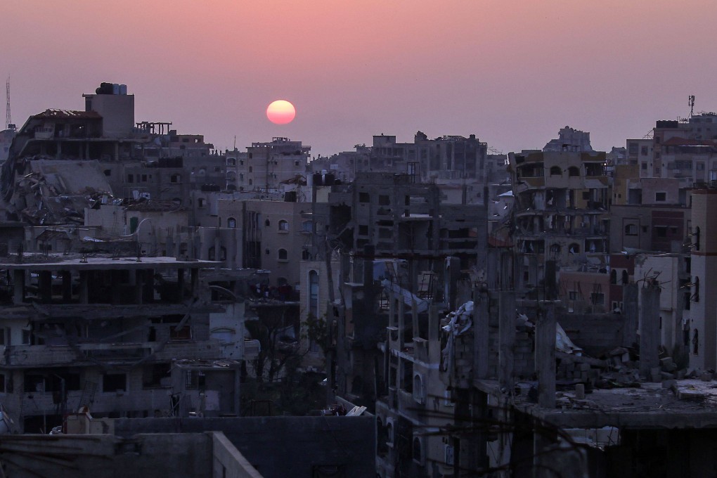 The sun sets behind heavily damaged residential buildings in Jabalia, the northern Gaza Strip, on Monday. Photo: AFP