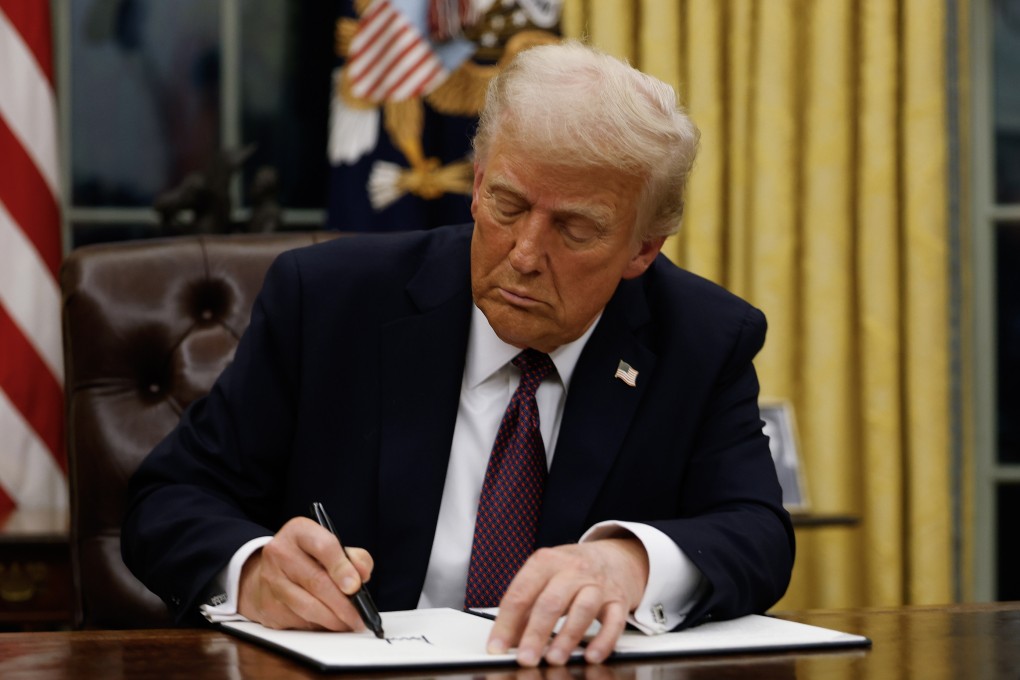 US President Donald Trump signs executive orders in the Oval Office. Photo: TNS