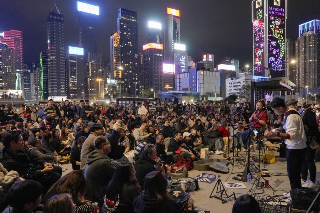 The Flame busking at the Wan Chai waterfront to a crowd of hundreds of people. Photo: Sophie Li