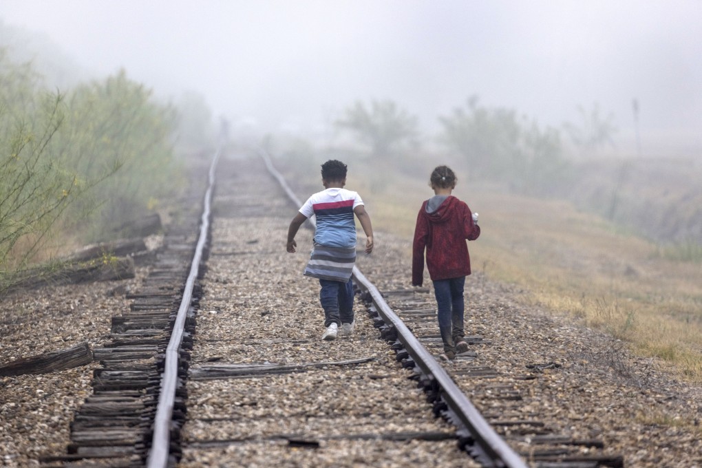 Children walk towards US border patrol agents near the US-Mexico border in La Joya, Texas, in 2021. The US is seeking to deport hundreds of thousands of youngsters who entered the country illegally, and without their parents. Photo: AFP