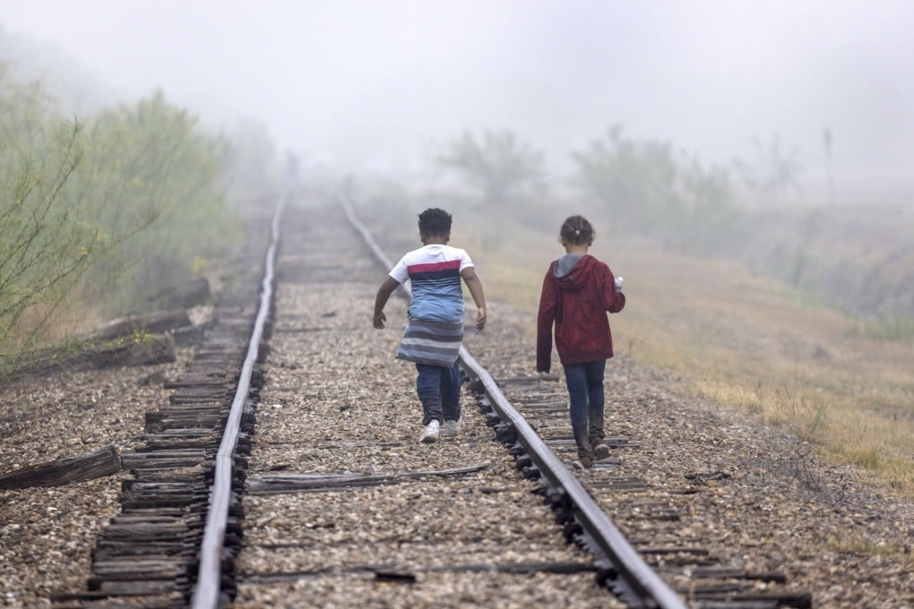 Children walk towards US border patrol agents near the US-Mexico border in La Joya, Texas, in 2021. The US is seeking to deport hundreds of thousands of youngsters who entered the country illegally, and without their parents. Photo: AFP