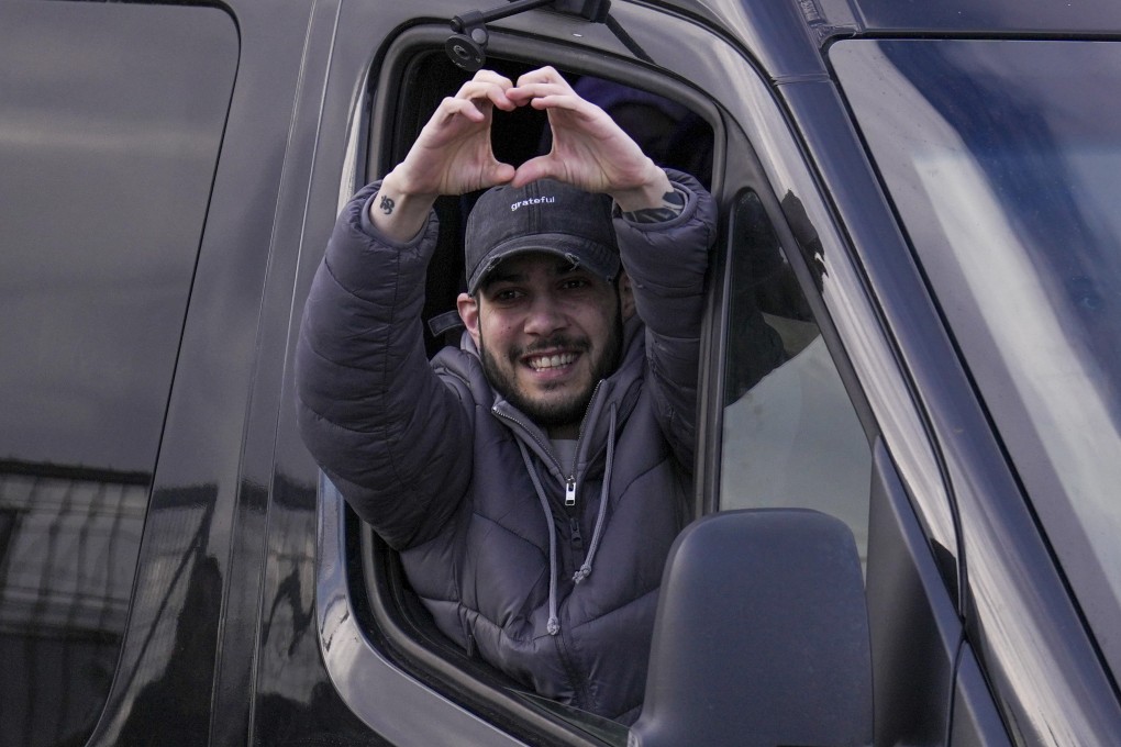 Freed hostage Eliya Cohen gestures from a van as he arrives at Beilinson hospital in Petah Tikva, Israel,  on Saturday. Photo: AP