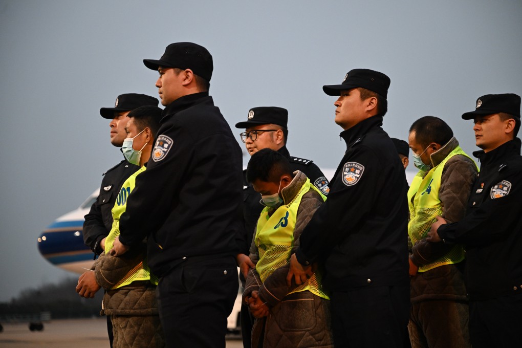 Chinese police escort Chinese nationals suspected of being involved in telecoms fraud after they were repatriated from  Myanmar, in Nanjing on February 20. Photo: Xinhua