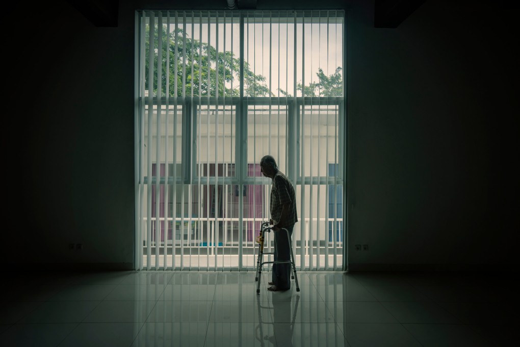 Silhouette of lonely old man walking near the window with a walker in the dark room ageing society elderly elder zimmer fram ID 1498775900 Photo: Shutterstock