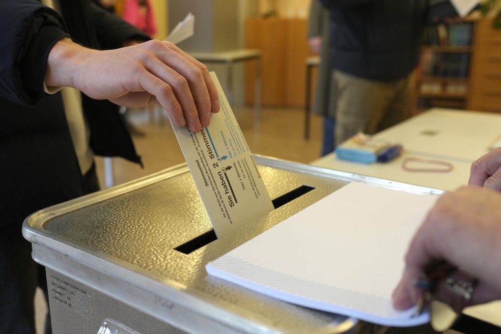 A resident casts a vote at a polling station in Berlin, Germany on February. 23, 2025, during the German national election. Photo: AP