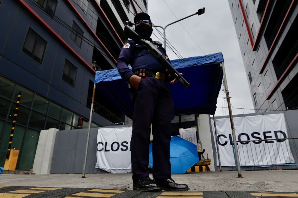 Security officers stand guard at the gates of a closed online gambling building, the largest Pogo hub in the country, in the town of Kawit, Cavite province, Philippines, in December 2024. Photo: EPA-EFE
