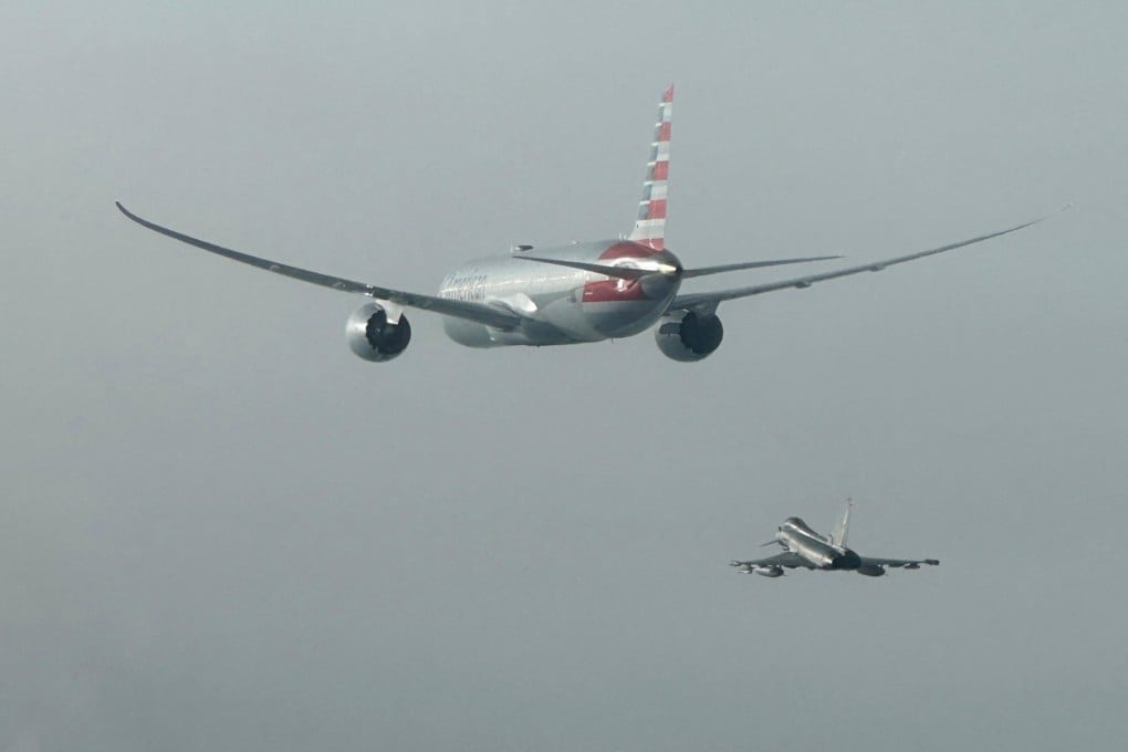 An Italian Air Force Eurofighter aircraft escorts an American Airlines plane. Photo: Italian Air Force via Reuters