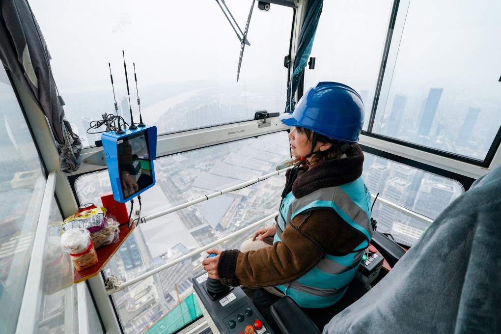A crane operator sits high above Nanjing Financial City’s construction site in Jiangsu province, on March 6, 2024. Photo: Xinhua