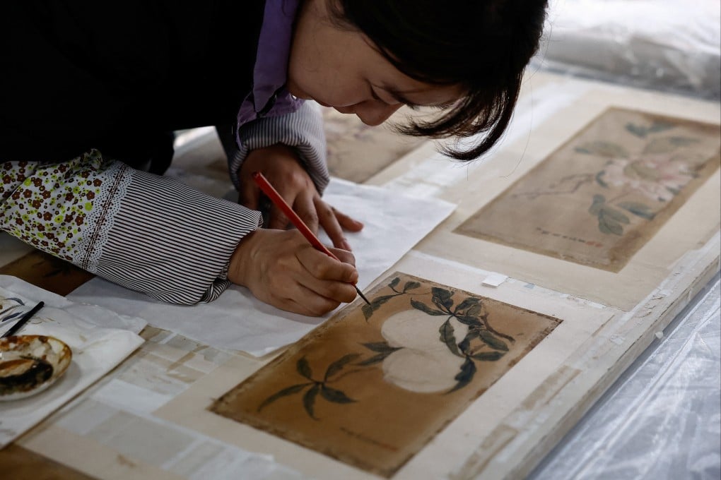 A conservator restores a relic at the Palace Museum in the Forbidden City in Beijing. A new branch opening in the Chinese capital this year will show more of the museum’s vast collection of treasures. Photo: Reuters