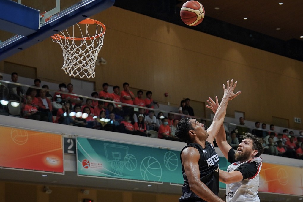 Hong Kong’s Duncan Reid shoots a layup against New Zealand’s Tai Wynyard in their Fiba Asia Cup qualifier last Thursday. Photo: Elson Li