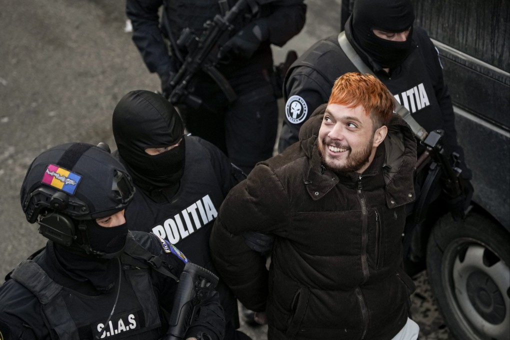 Police officers escort Mohamed Amra after a court hearing in Bucharest. Photo: AP