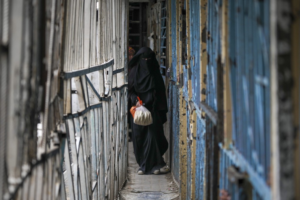 A Palestinian woman walks out of a bakery in Gaza City on Monday. Photo: AP